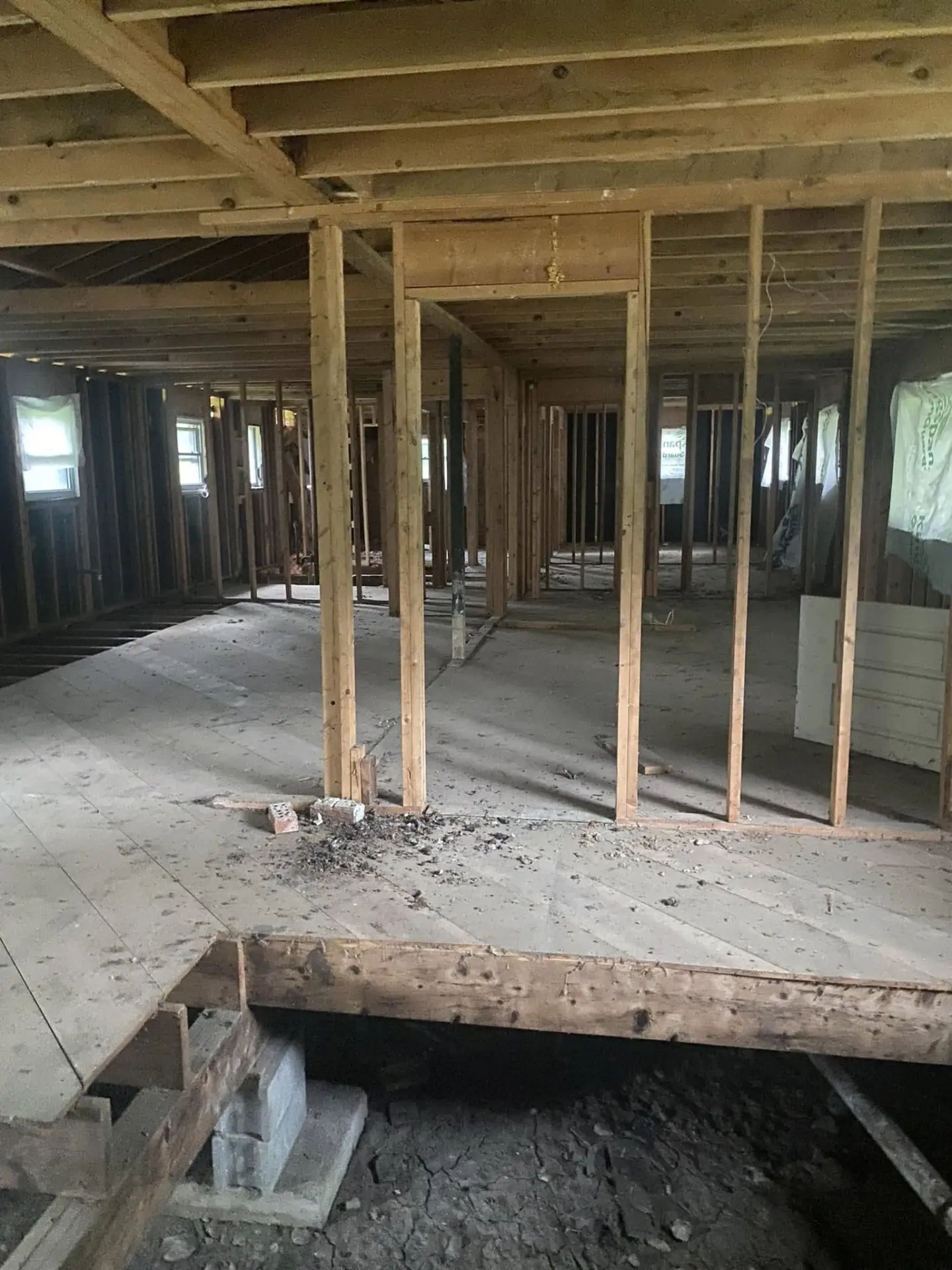Open framed interior with exposed floor joists during a remodel